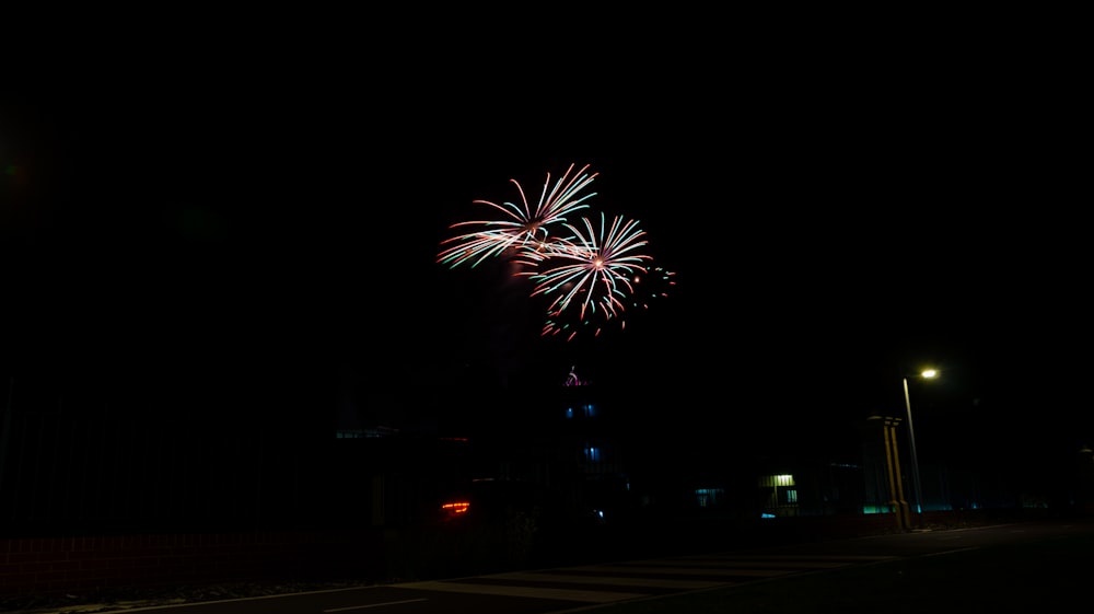 a firework is lit up in the night sky