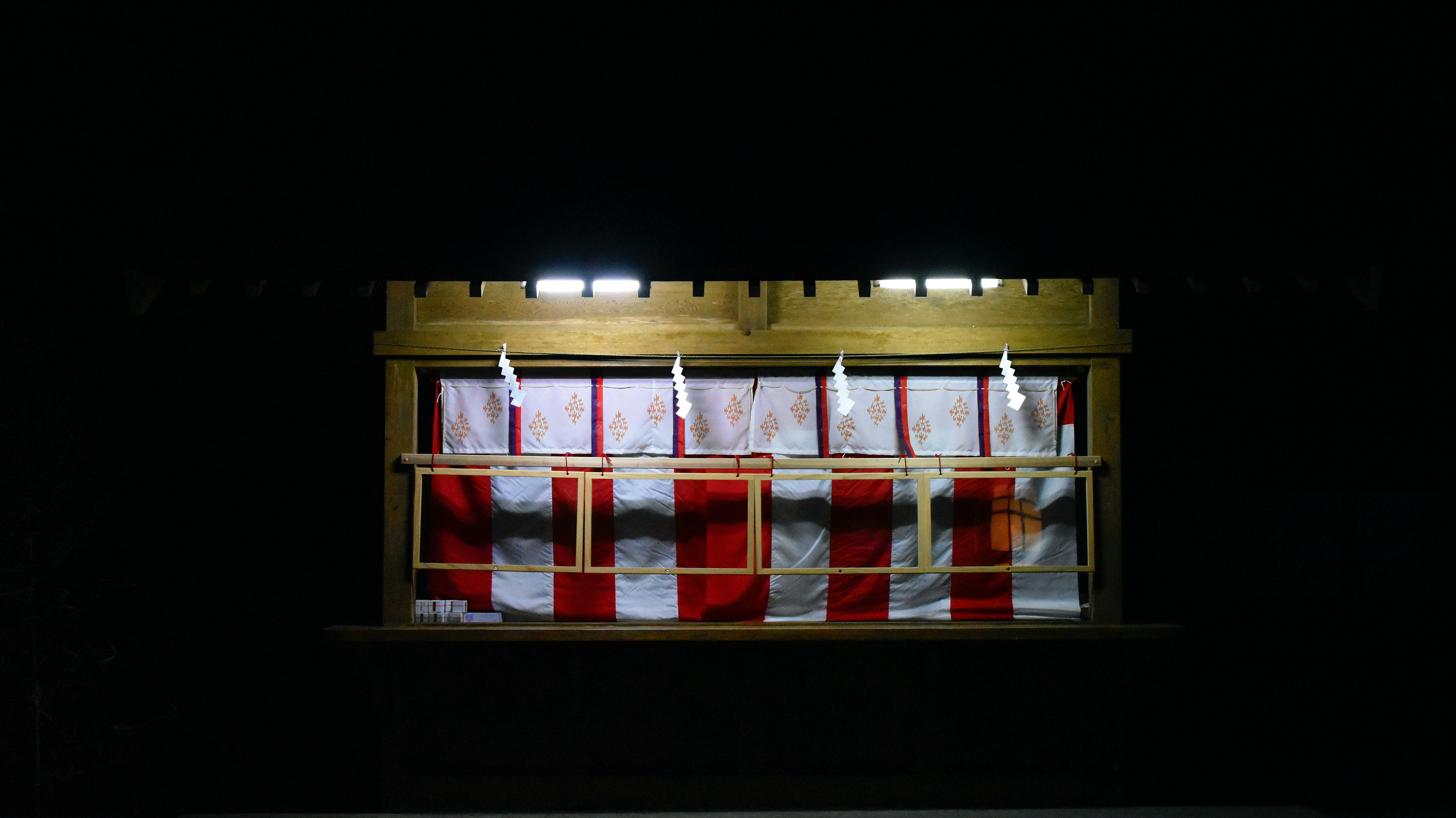 window in a dark room with lit candles