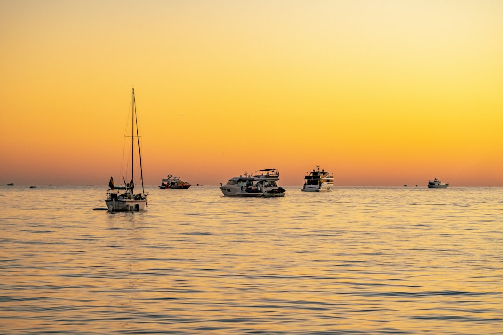 a group of boats floating on top of a large body of water