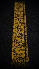 a yellow line painted on the side of a road