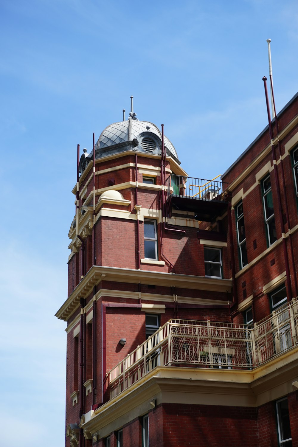 a tall red brick building with a clock on the top of it