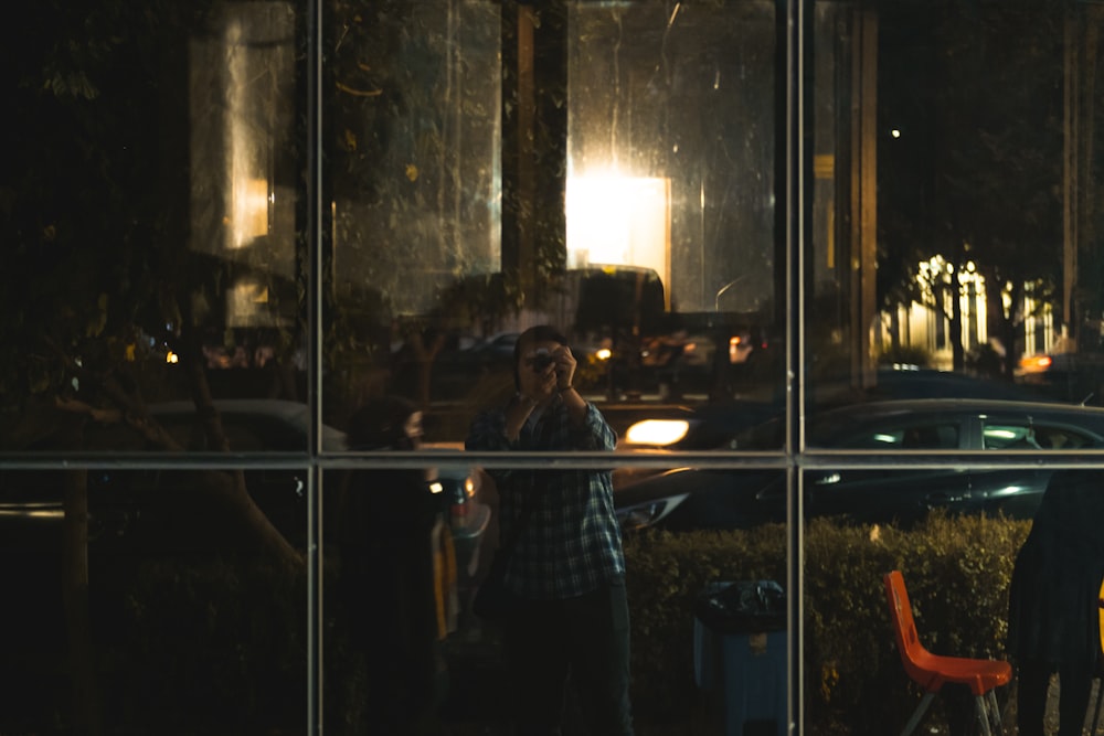 a reflection of a man and woman in a window