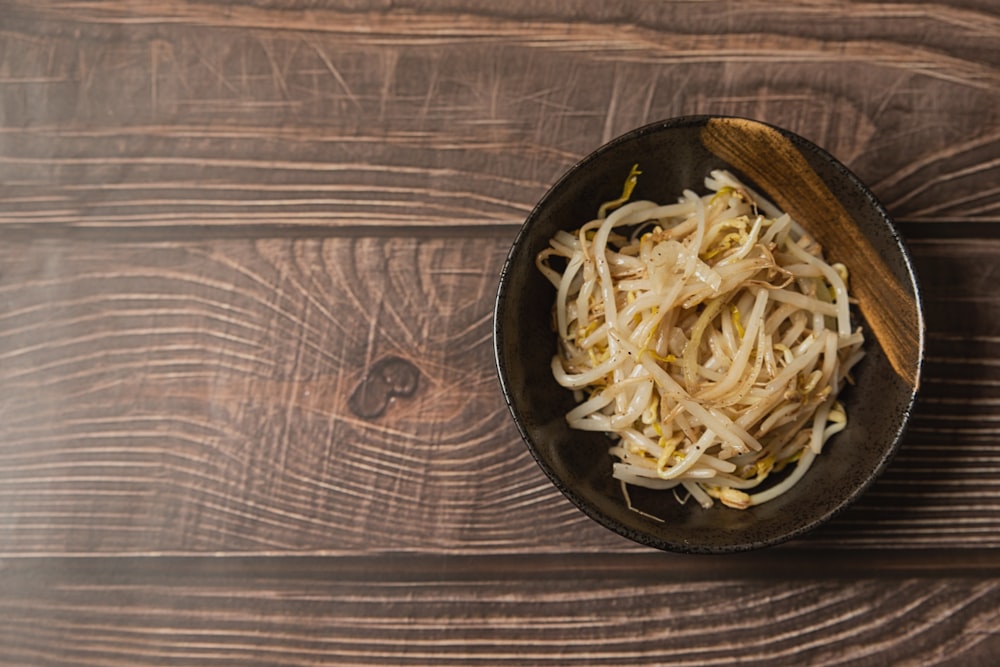 a bowl of noodles on a wooden table