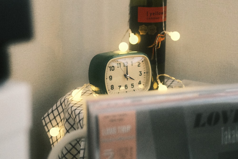 a bottle of wine and a clock on a table