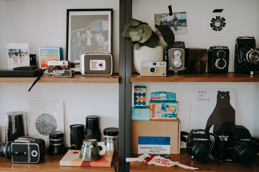 a couple of shelves filled with cameras and other items