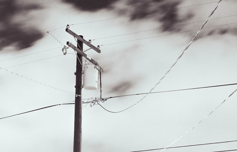 a black and white photo of a telephone pole