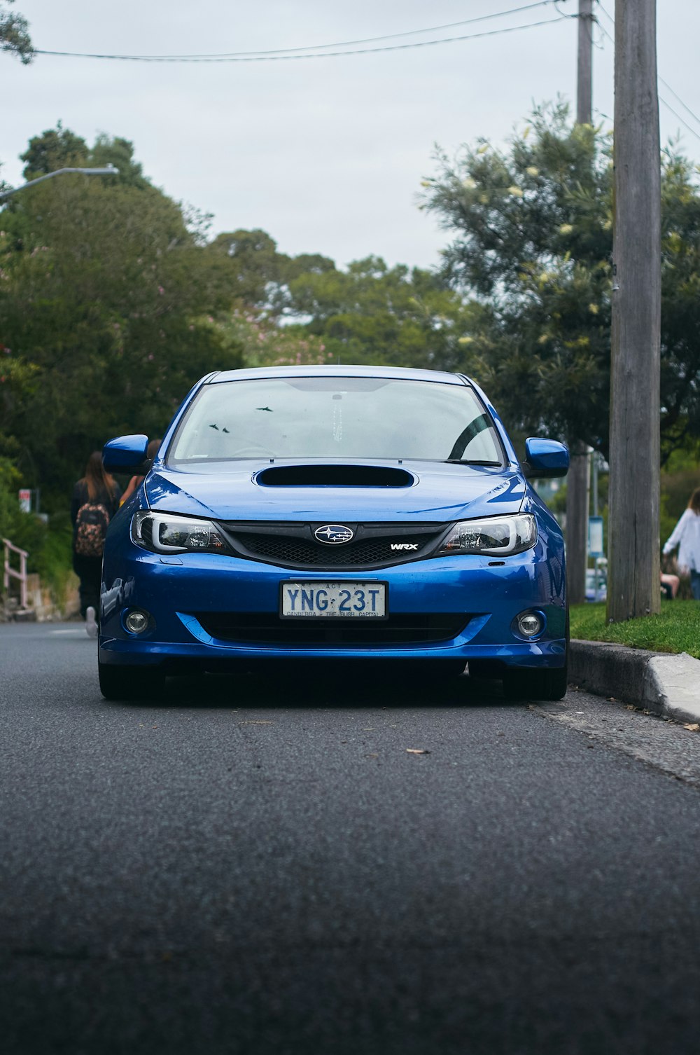 a blue car parked on the side of the road