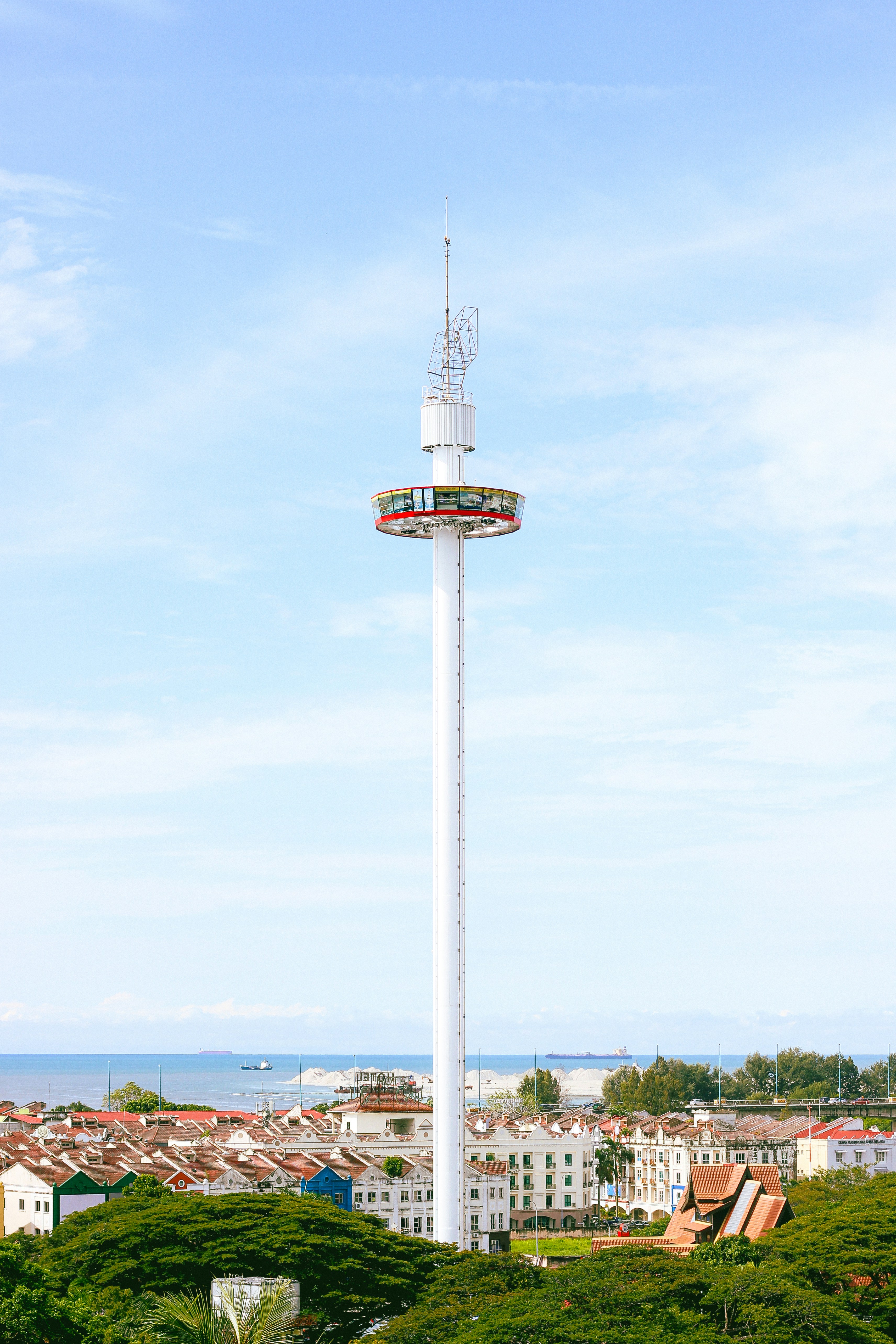 a tall white tower with a clock on top of it