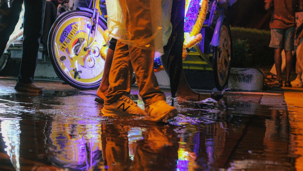 a group of people standing next to each other in the rain