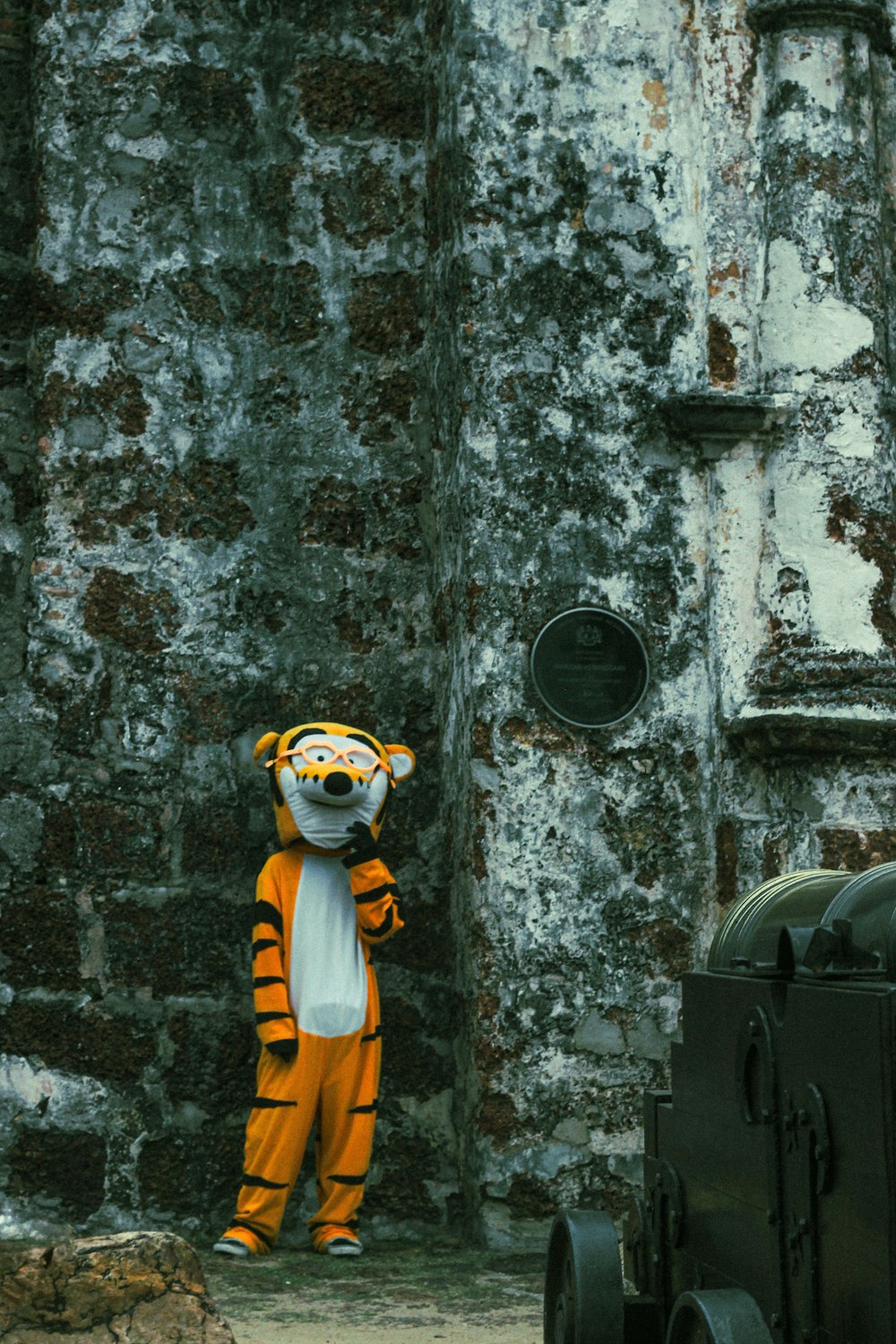 a person in a tiger costume standing next to a truck