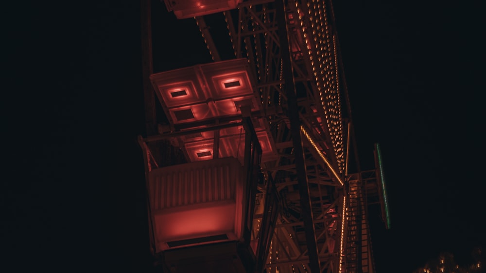 a tall tower with red lights on top of it