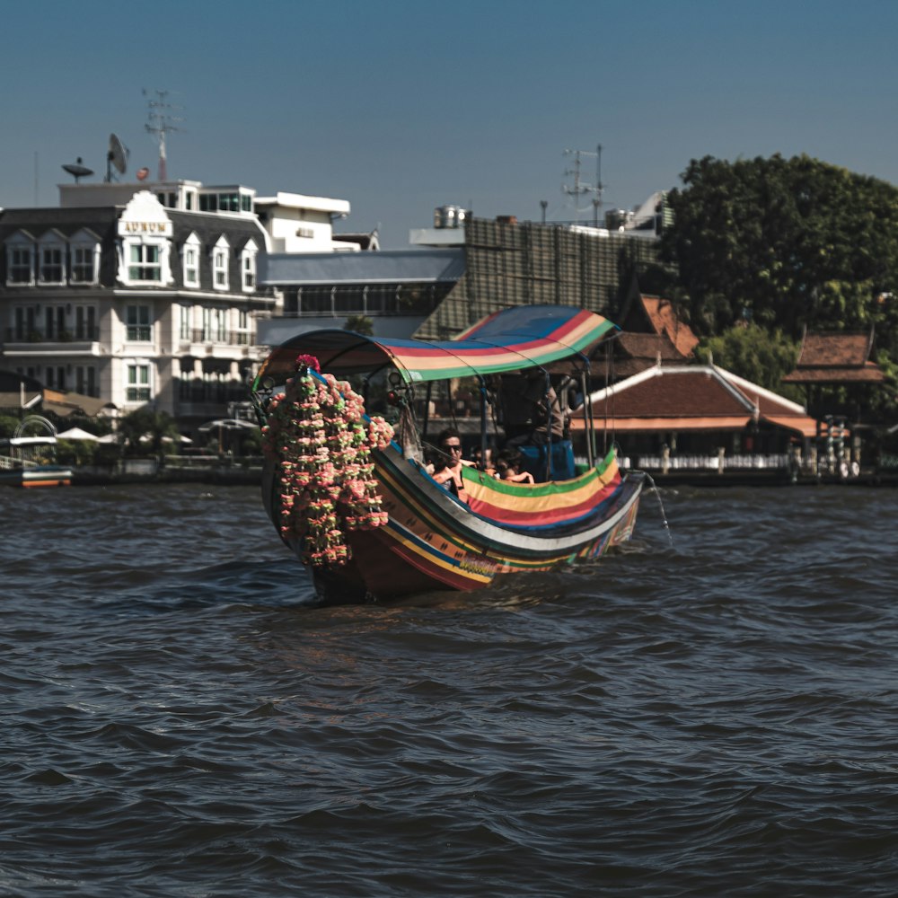 a boat filled with lots of items floating on top of a river