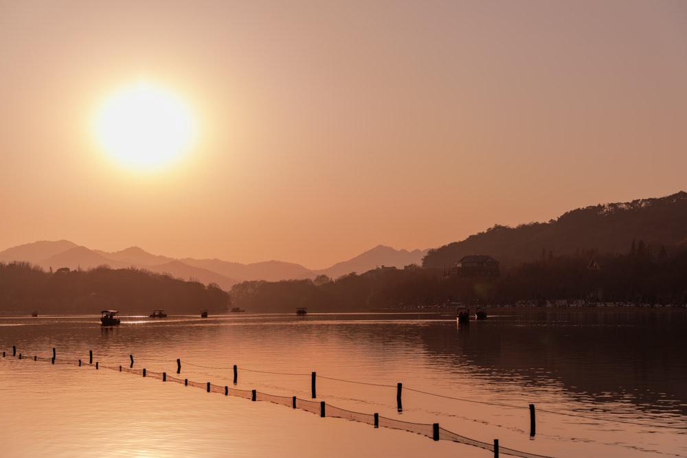 the sun is setting over a body of water