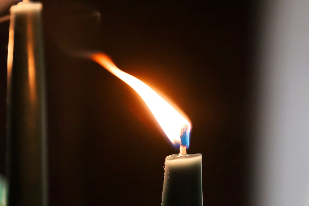 a close up of a lit candle with a blurry background