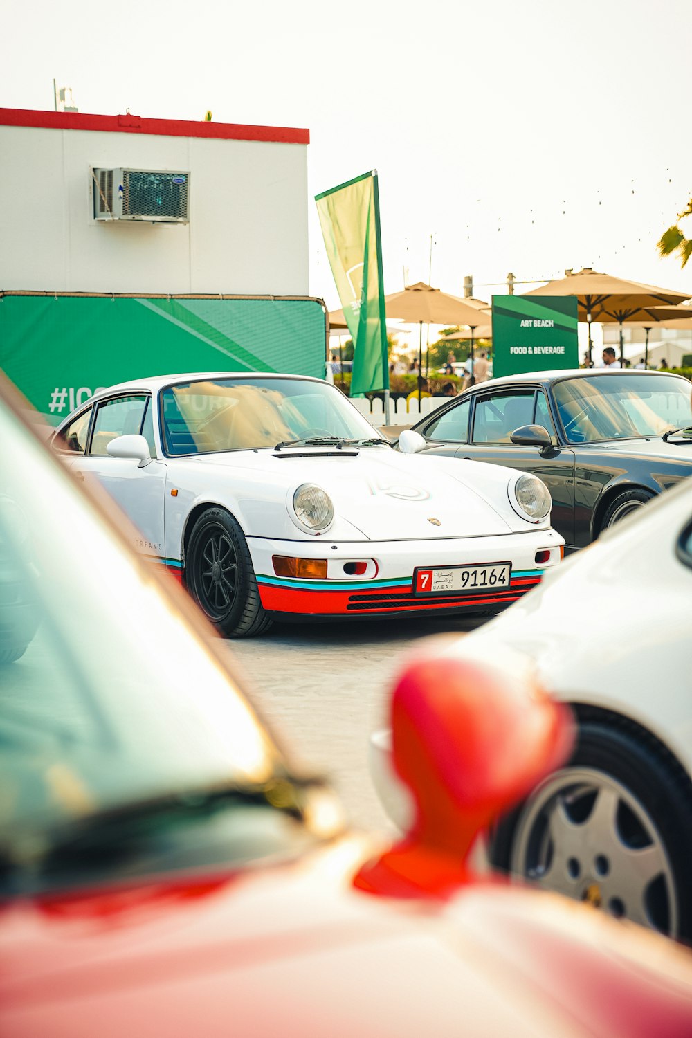 a group of cars parked next to each other in a parking lot