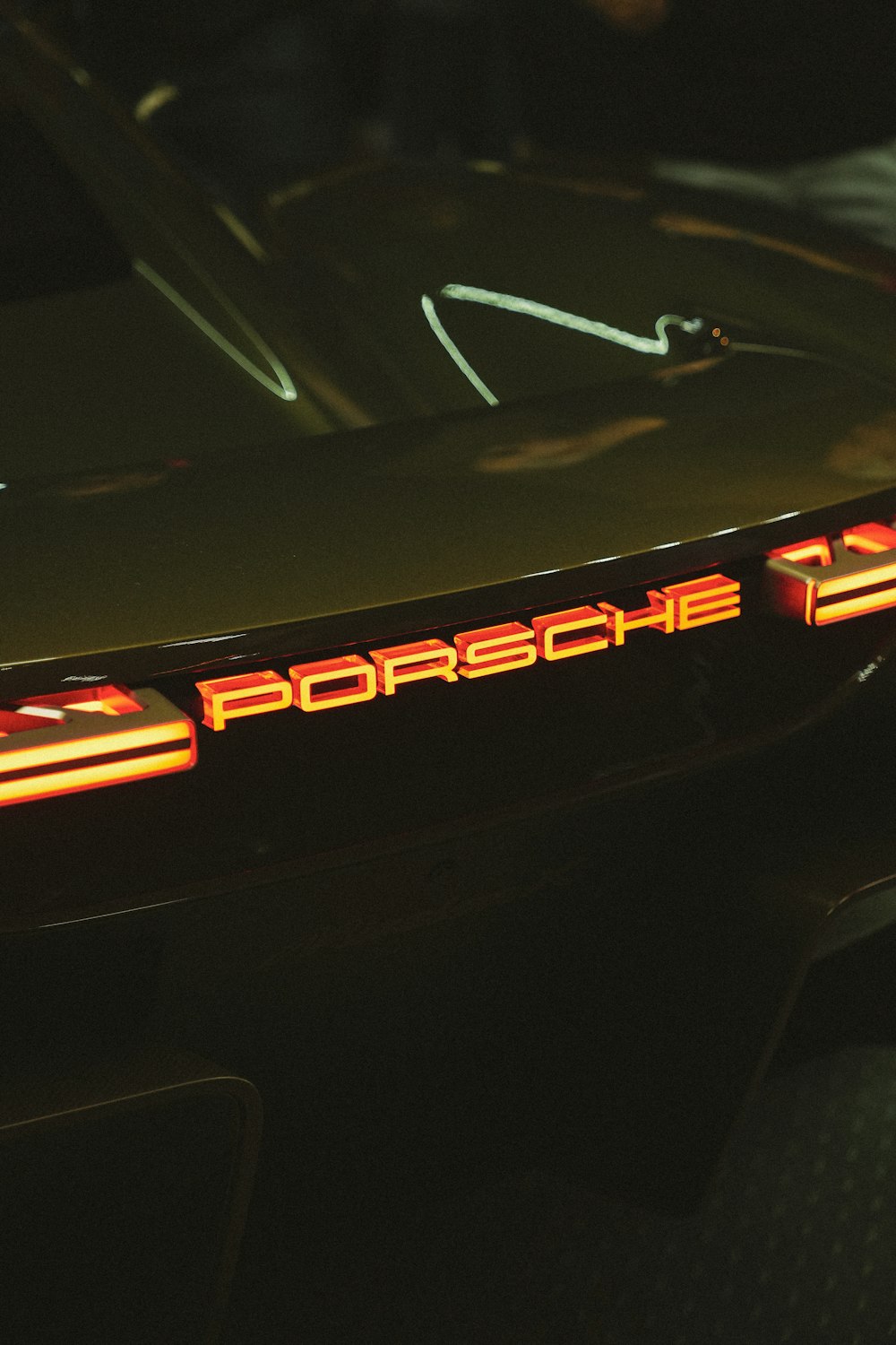 a close up of a porsche logo on a car