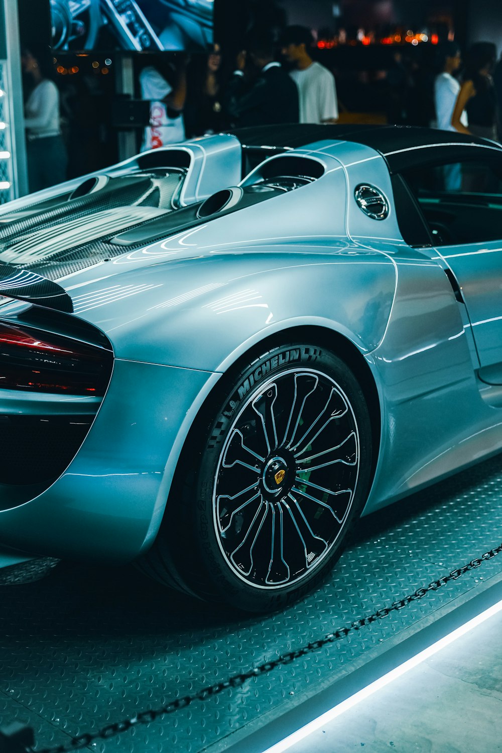 a silver sports car on display at a car show