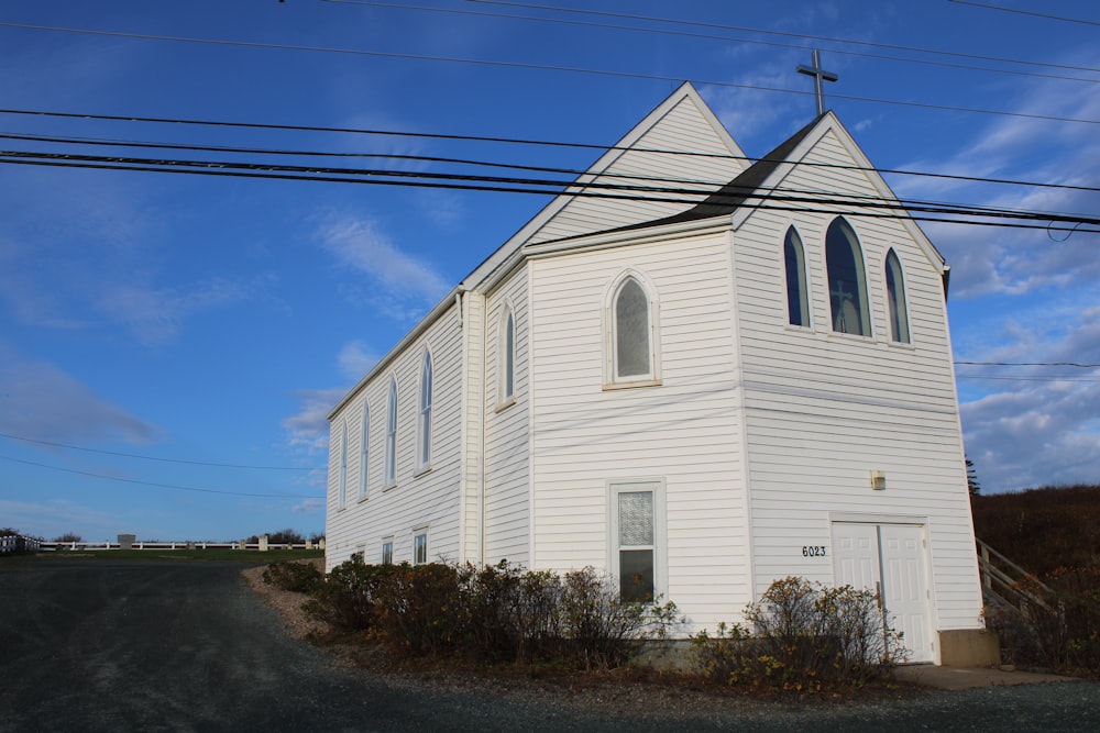 a white church with a cross on the top of it