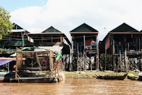 a group of houses sitting on top of a river
