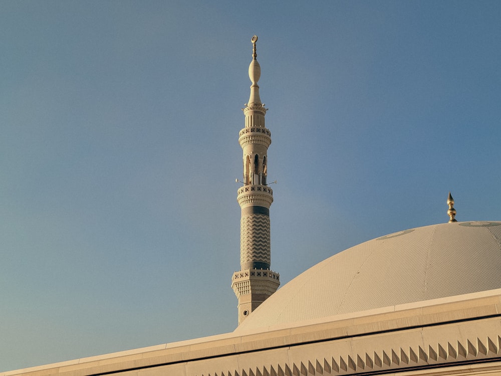 a tall white building with a clock on it's side