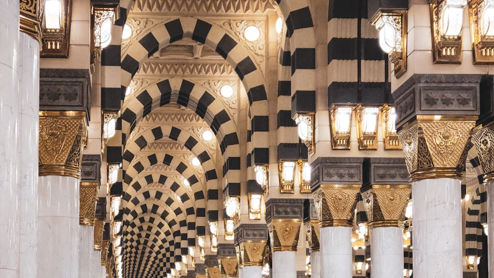 a hallway in a large building with columns and lights