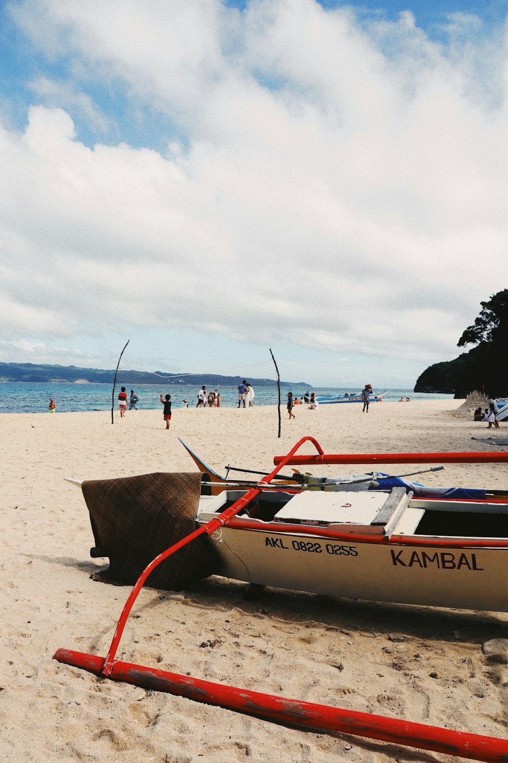 a boat sitting on top of a sandy beach