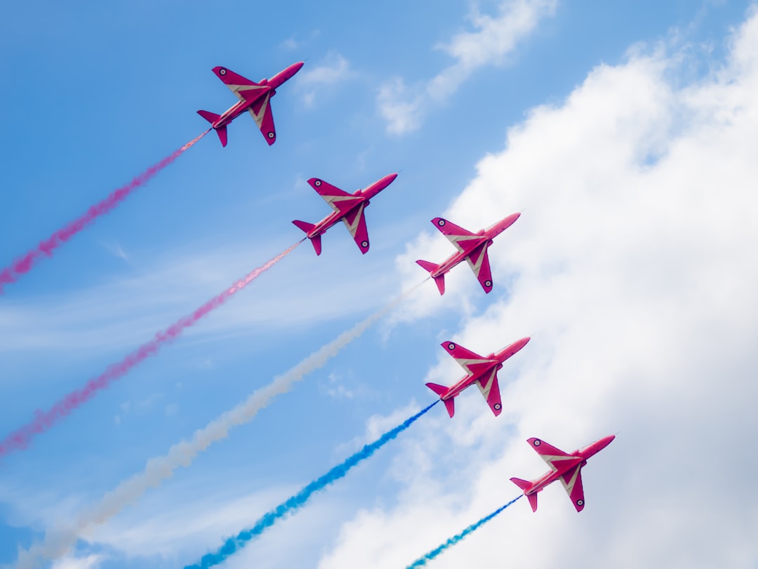 a group of jets flying through a blue cloudy sky, Red Arrows