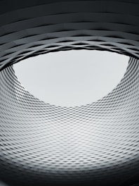 a circular window in a building with a sky in the background