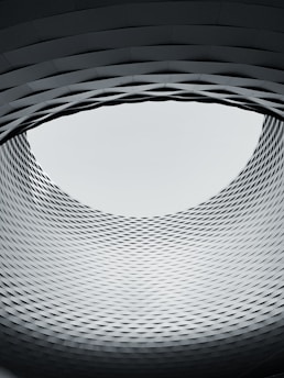 a circular window in a building with a sky in the background