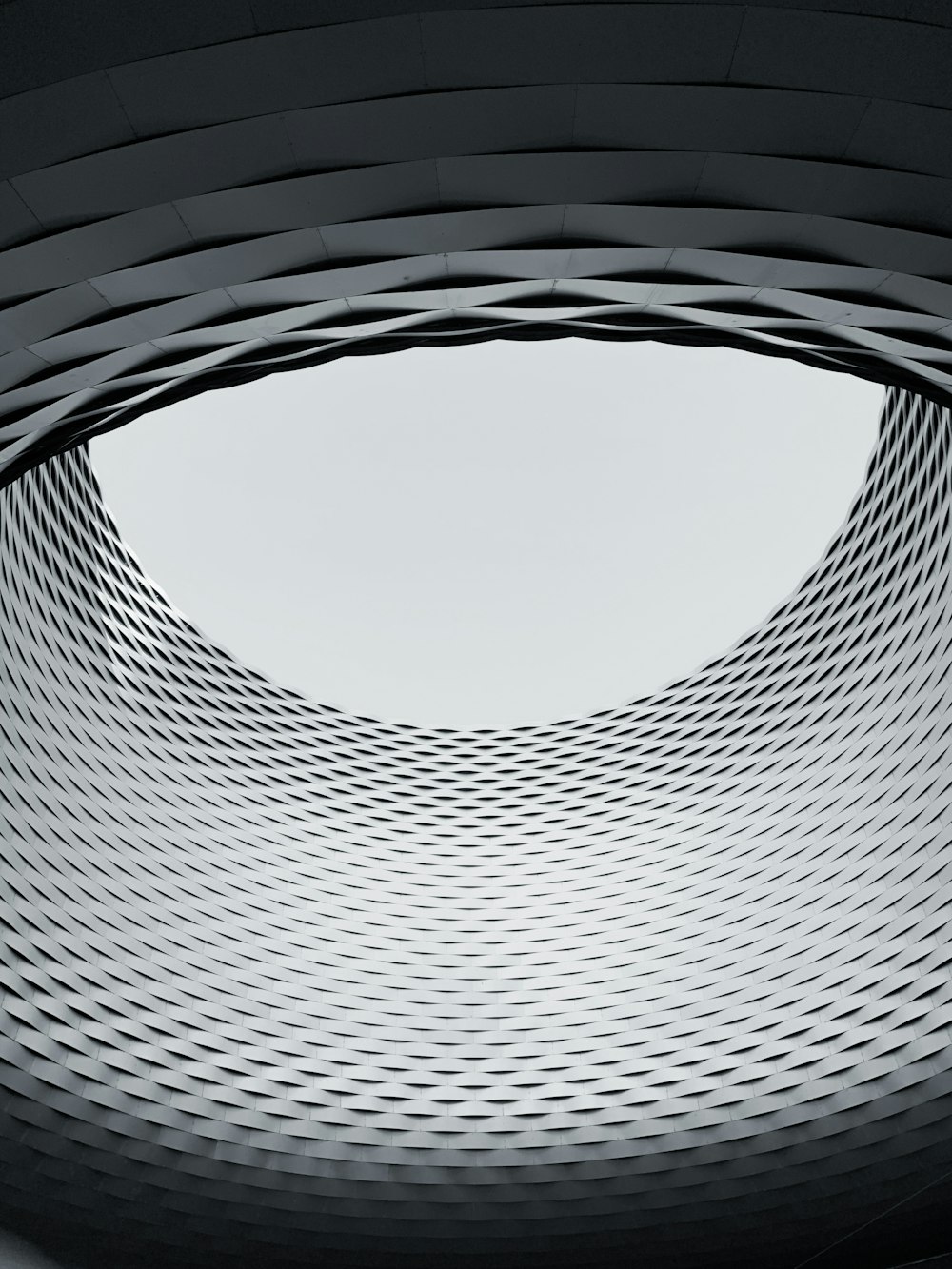 a circular window in a building with a sky in the background