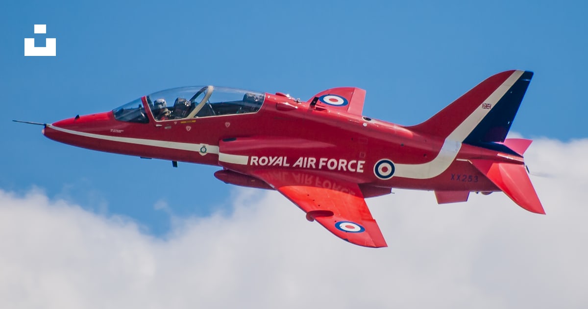 A red fighter jet flying through a blue sky photo – Free Aircraft Image ...