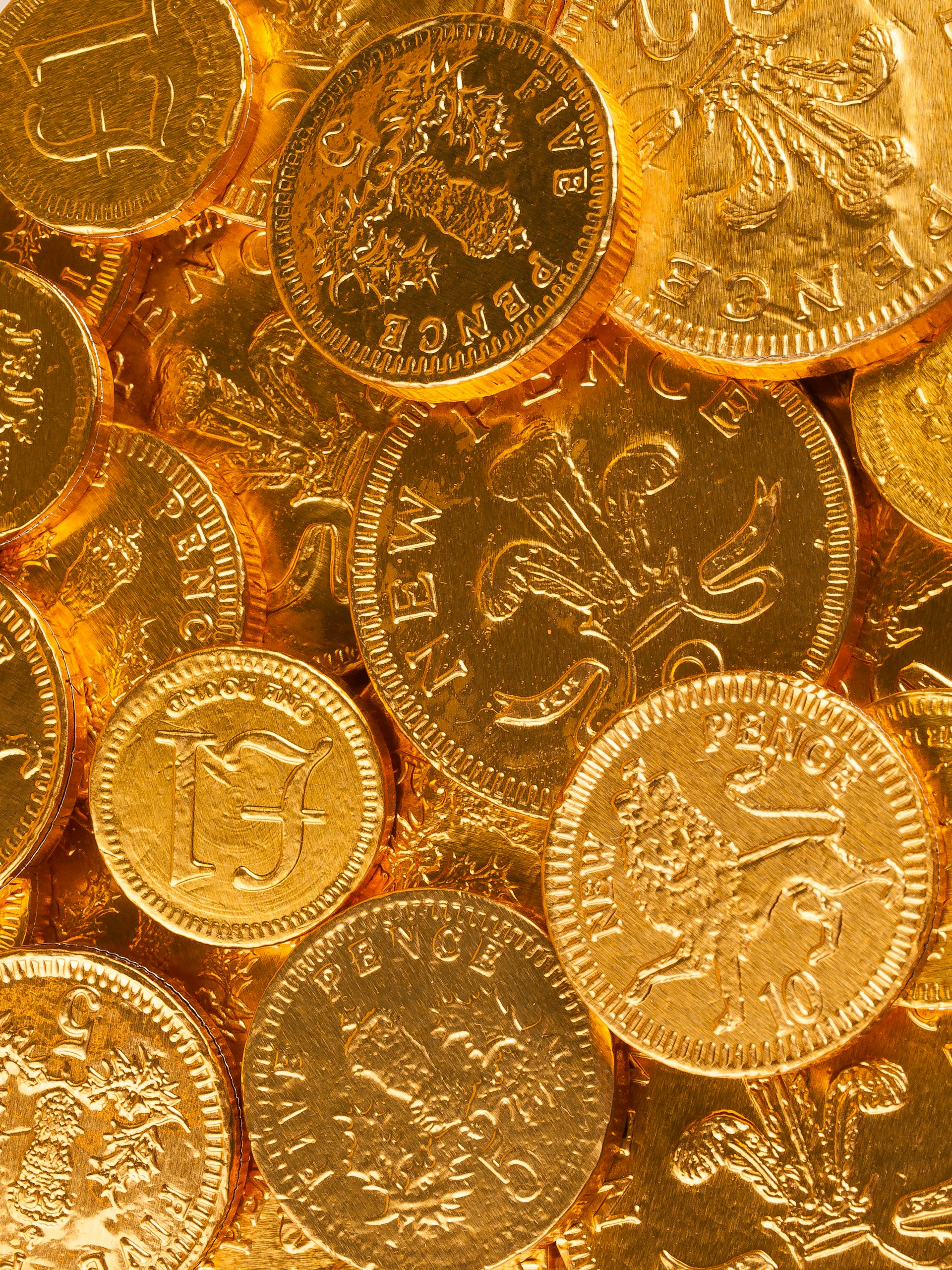 a pile of gold coins sitting on top of each other