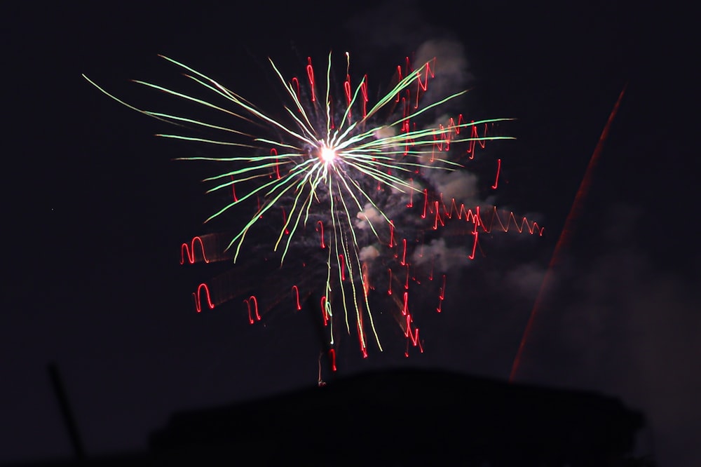 a firework is lit up in the night sky