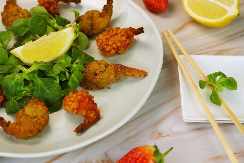 a white plate topped with shrimp and greens