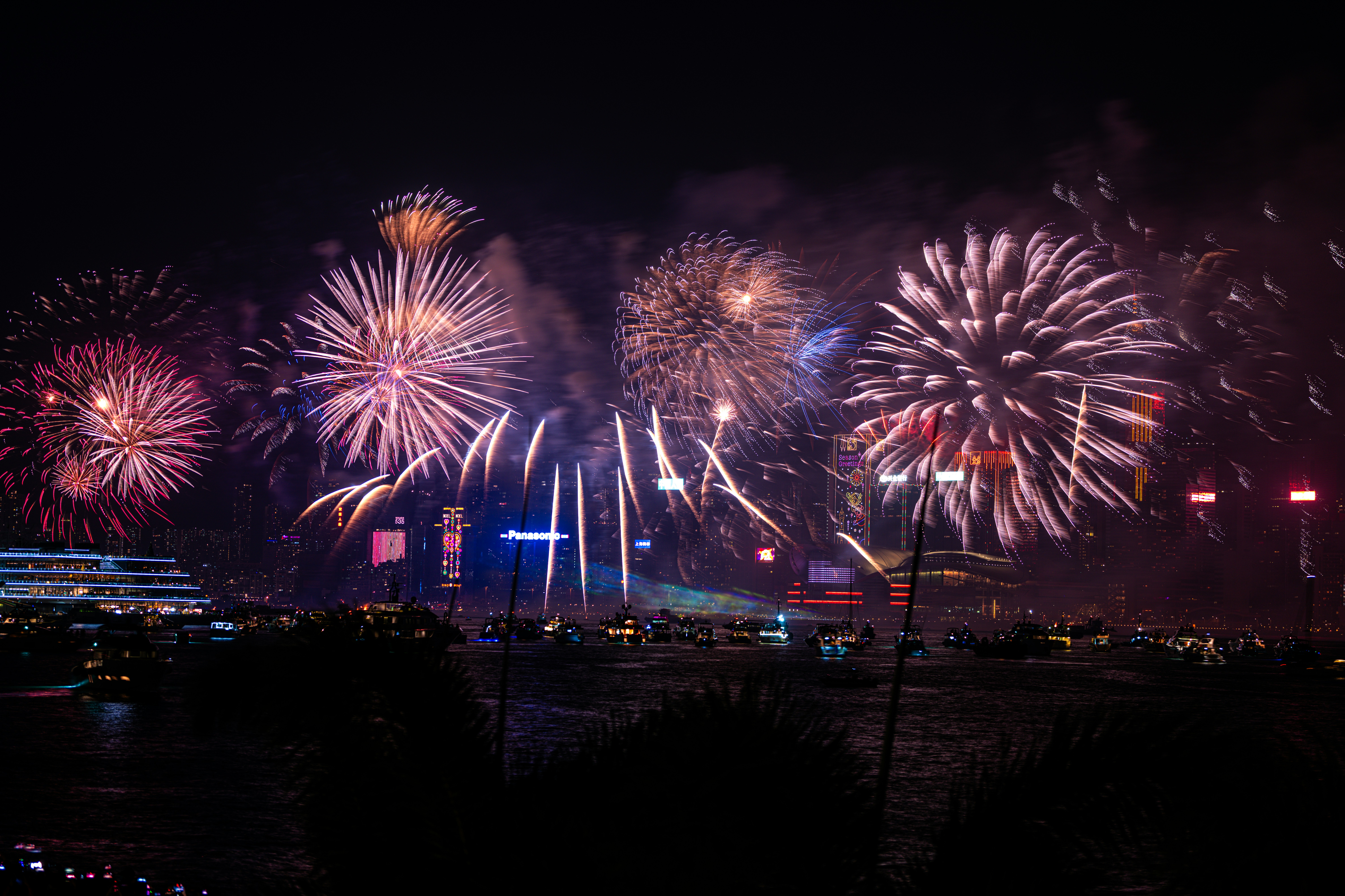 Des feux d’artifice sont allumés dans le ciel nocturne au-dessus d’une ville