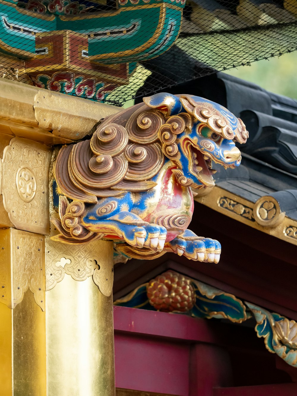 a close up of a statue of a dog on a pole