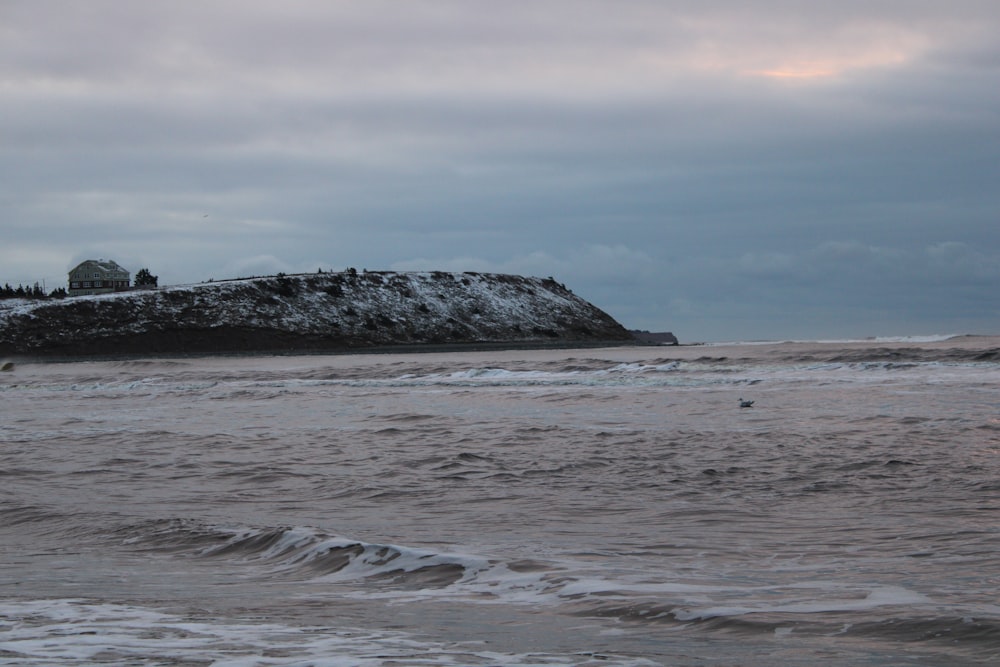 a large body of water with a small island in the background