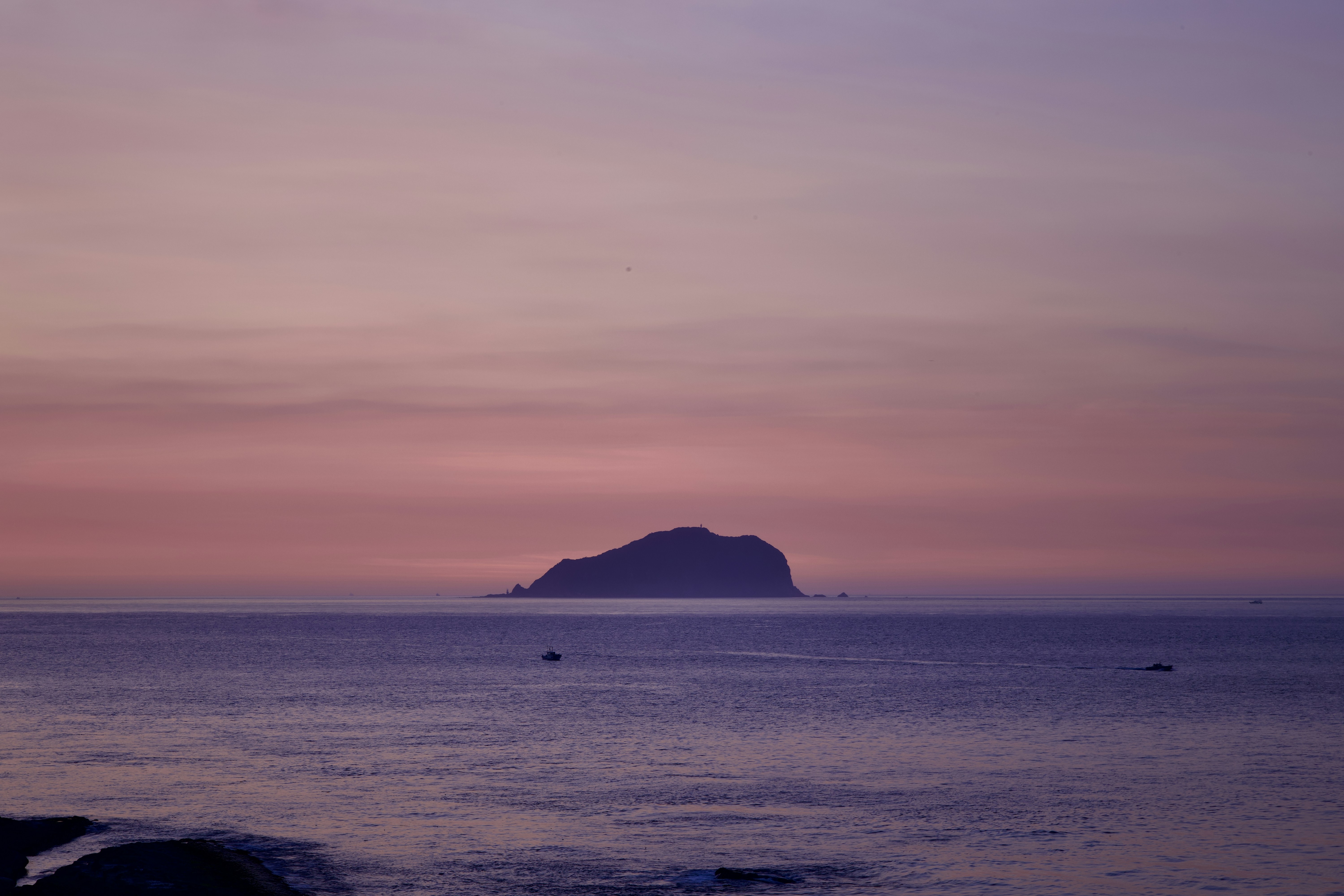a large body of water with a small island in the distance