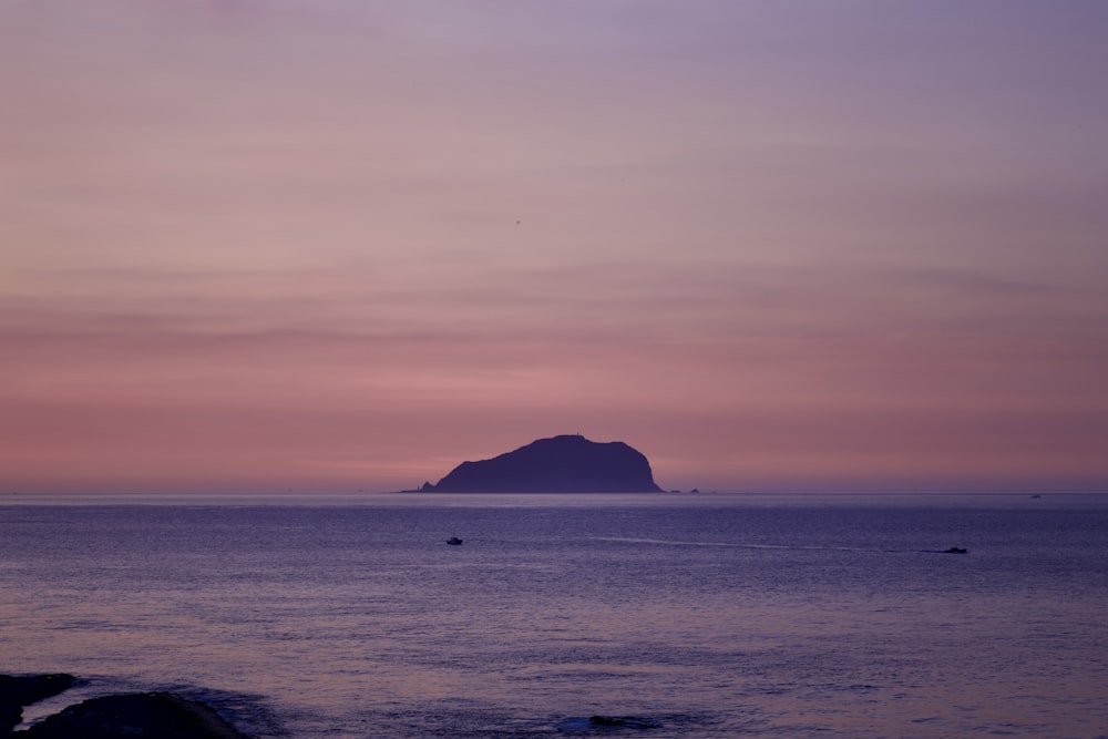 a large body of water with a small island in the distance