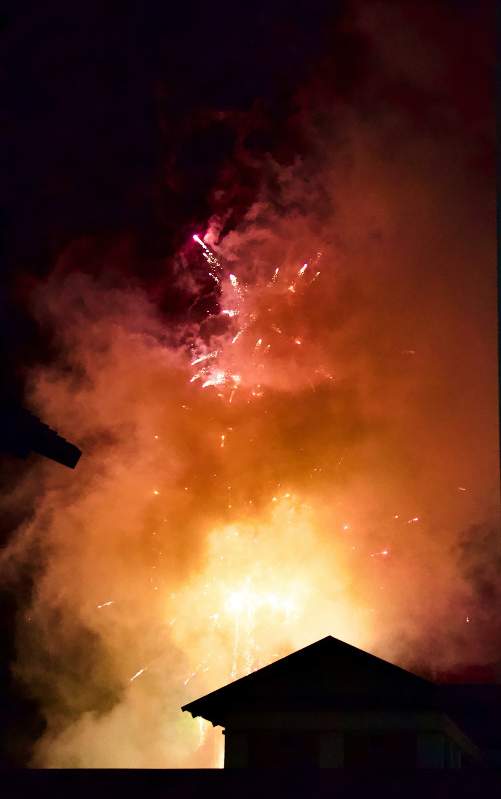 a large fireworks is lit up the night sky