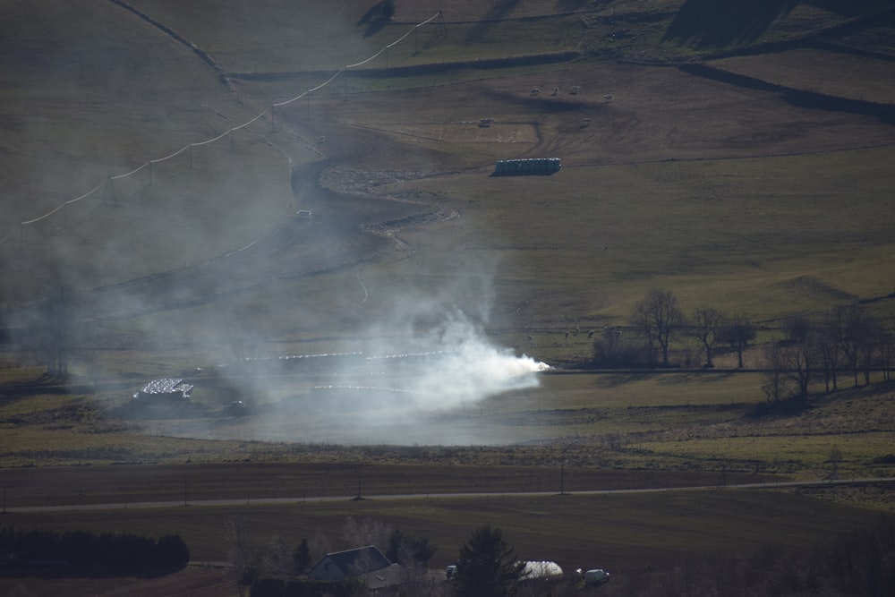 a field with a lot of smoke coming out of it