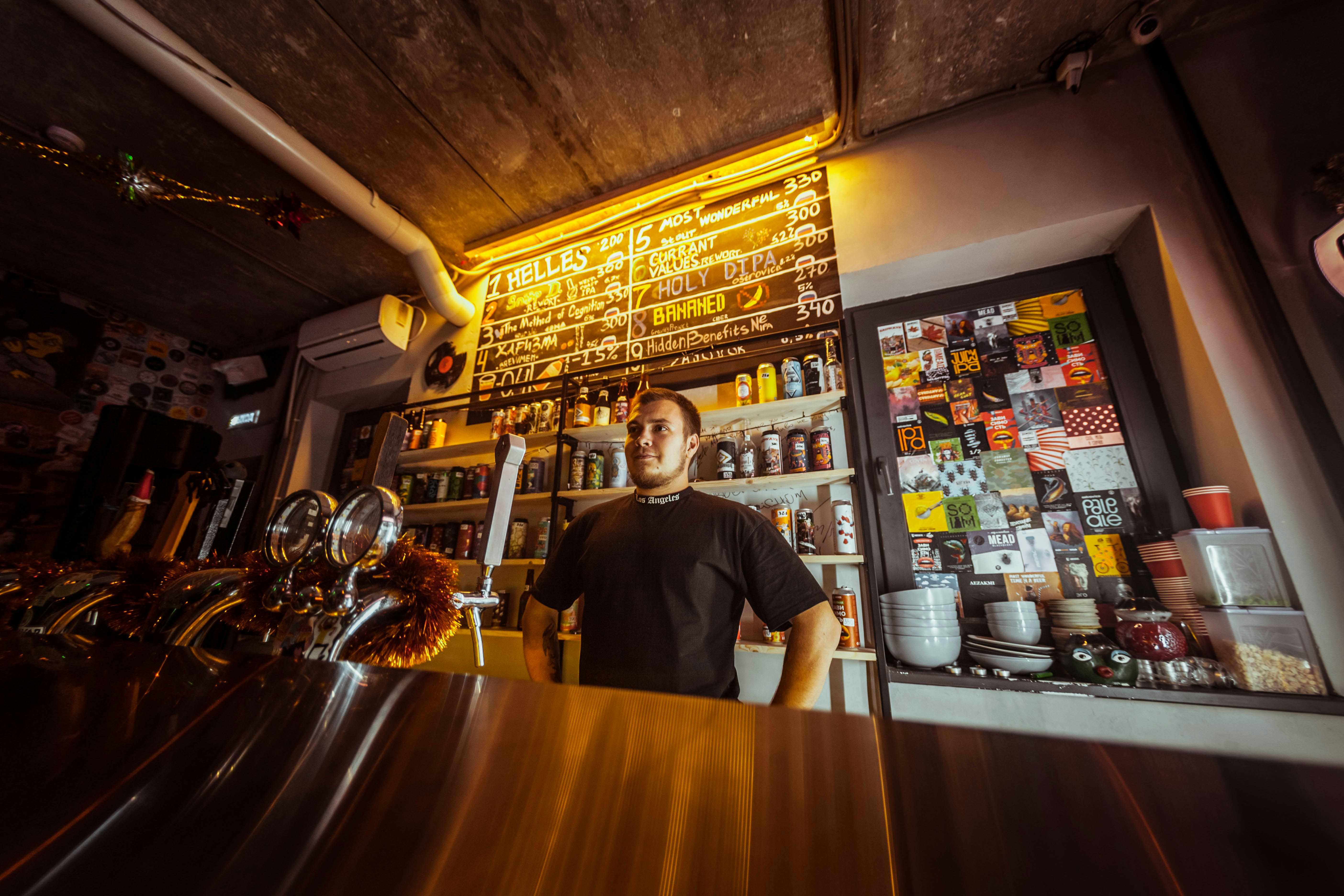 a man standing behind a counter in a restaurant