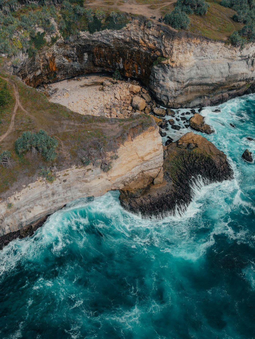 an aerial view of the ocean and cliffs