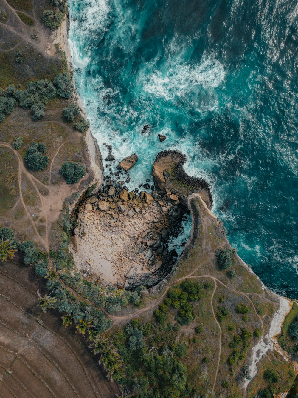 an aerial view of the ocean and land