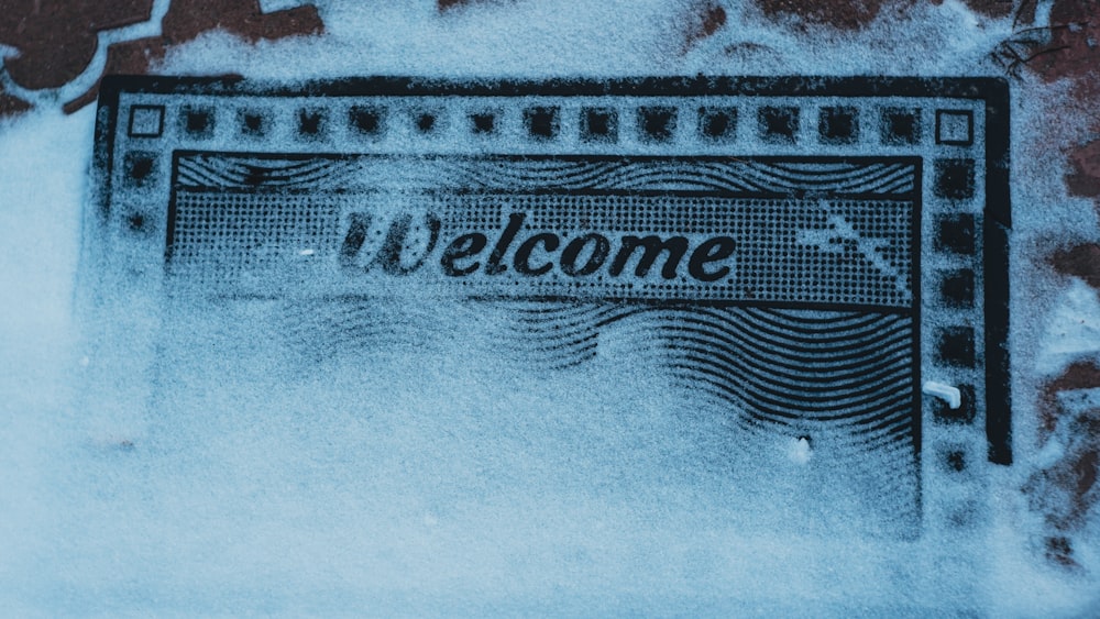 a picture of a welcome sign in the snow