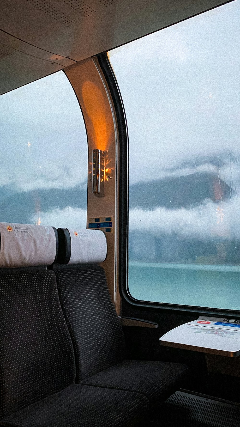 a train car with a view of a body of water