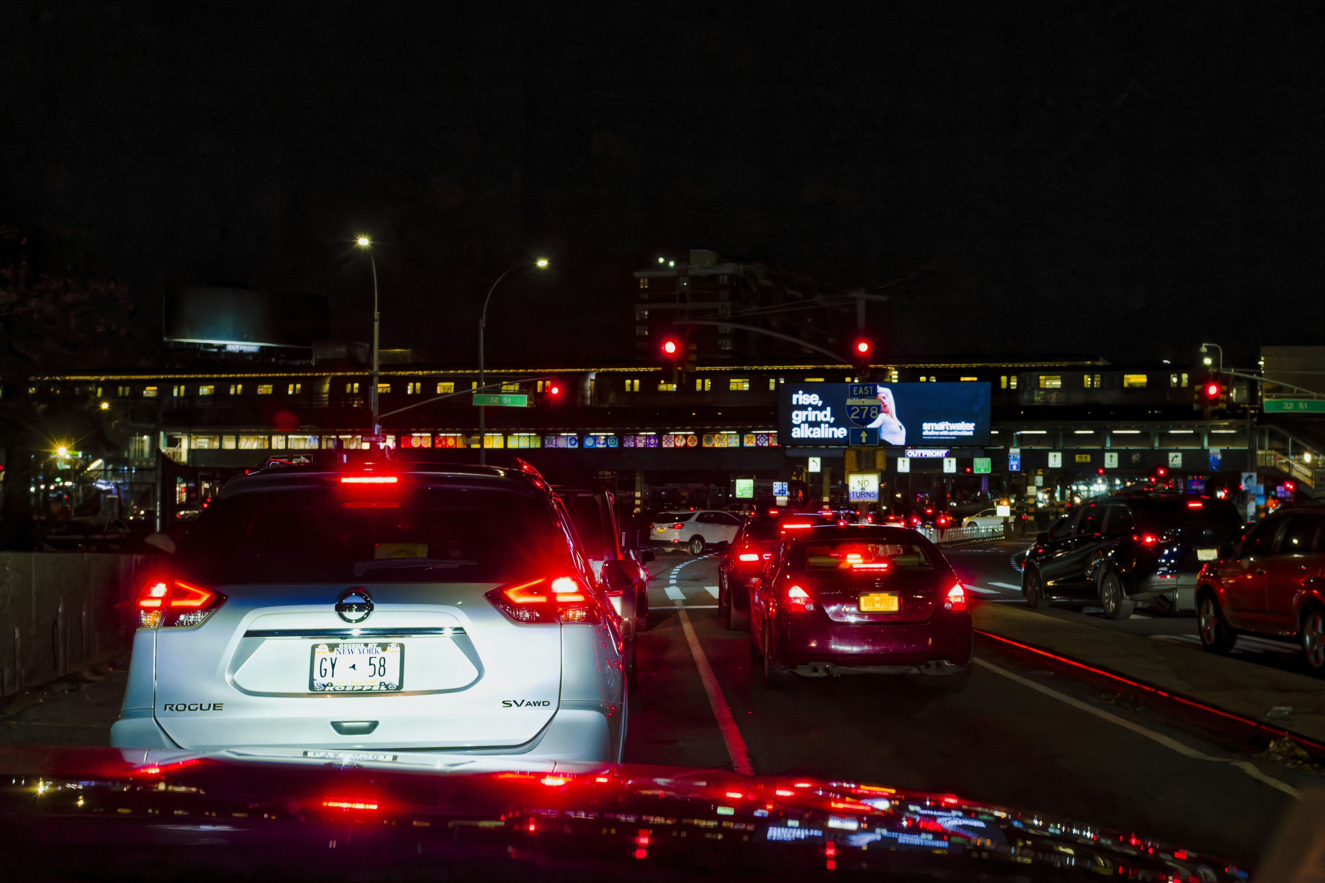 a city street filled with lots of traffic at night