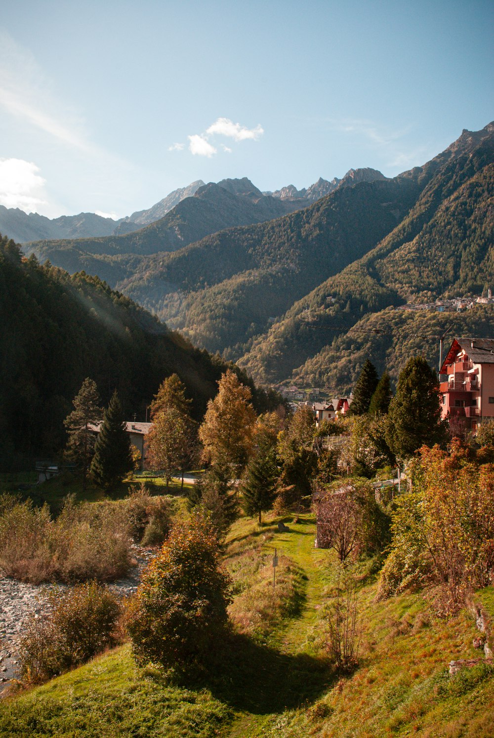 a scenic view of a valley with mountains in the background