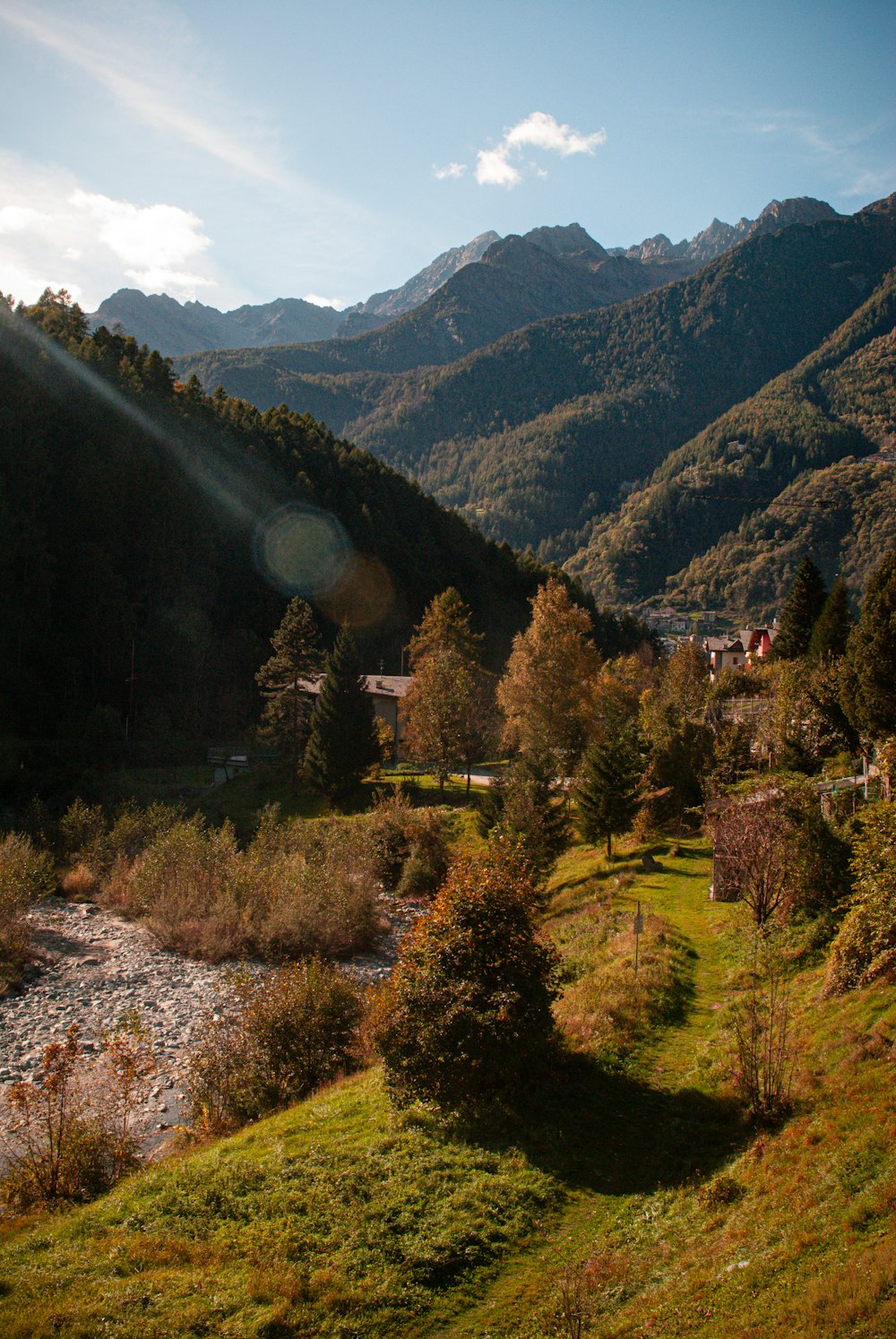 the sun shines brightly on a mountain valley