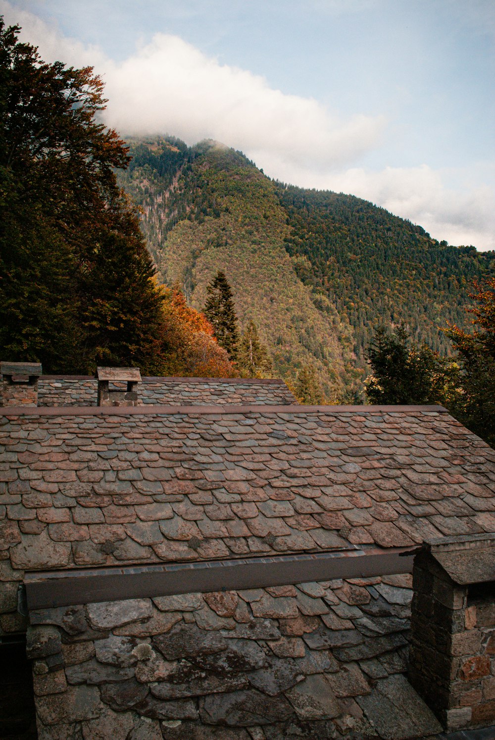 a stone building with a bench on top of it